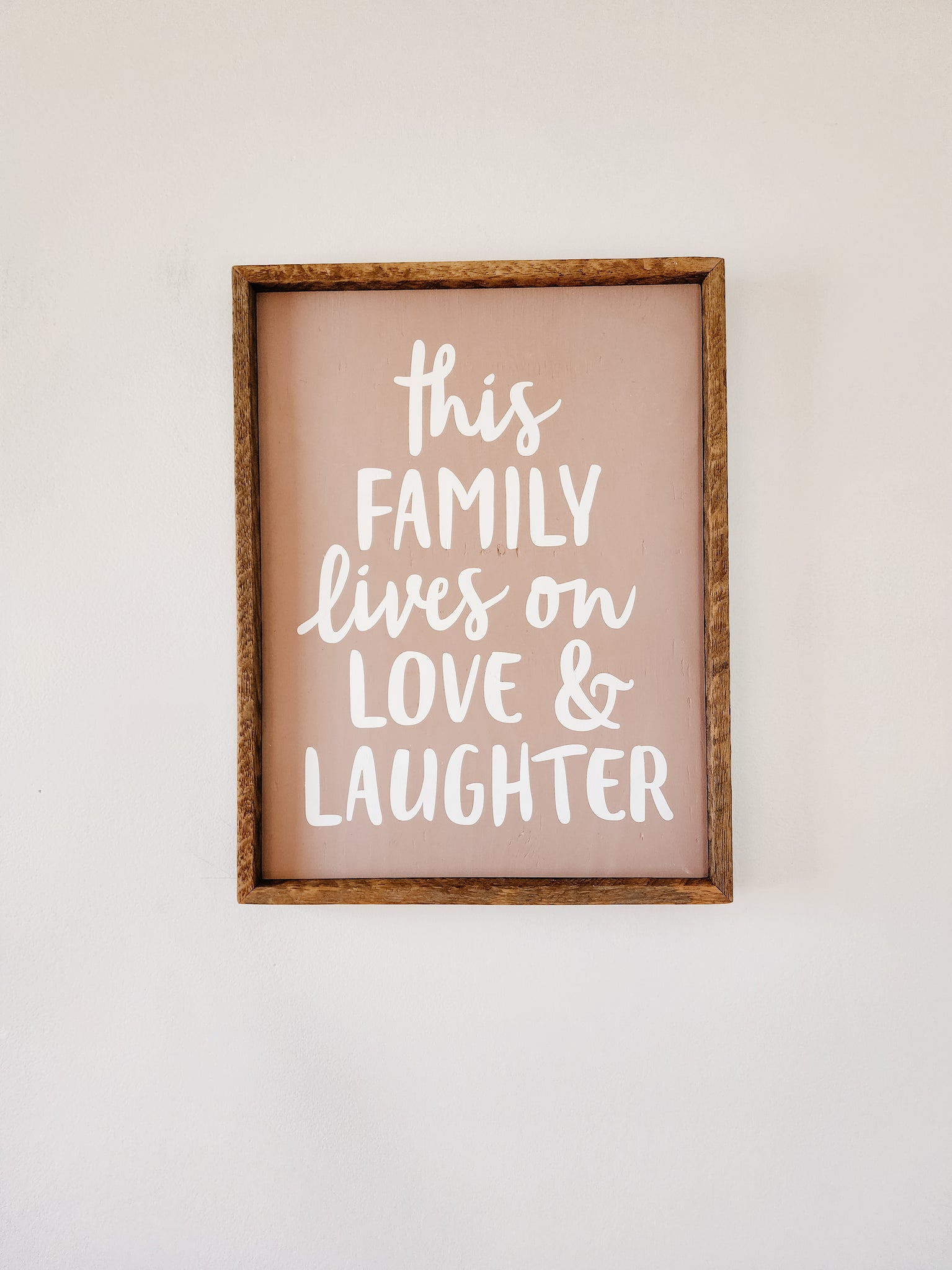 Ruastic 13x17 This family lives on love and laughter sign- dusty pink