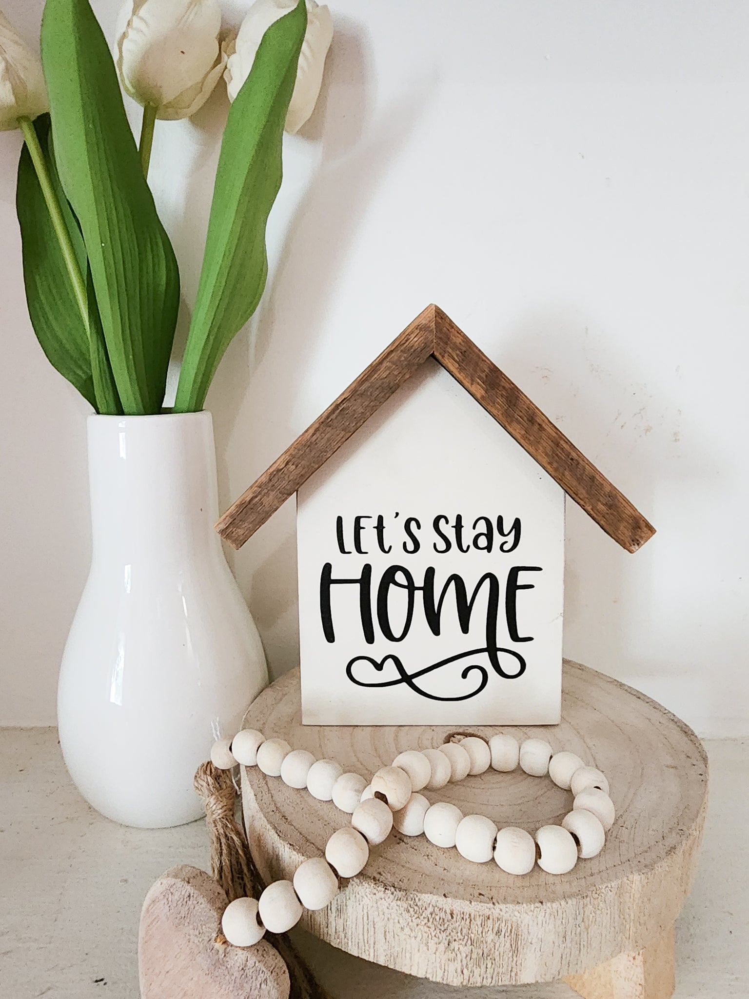 Small rustic house "let's stay home" sign