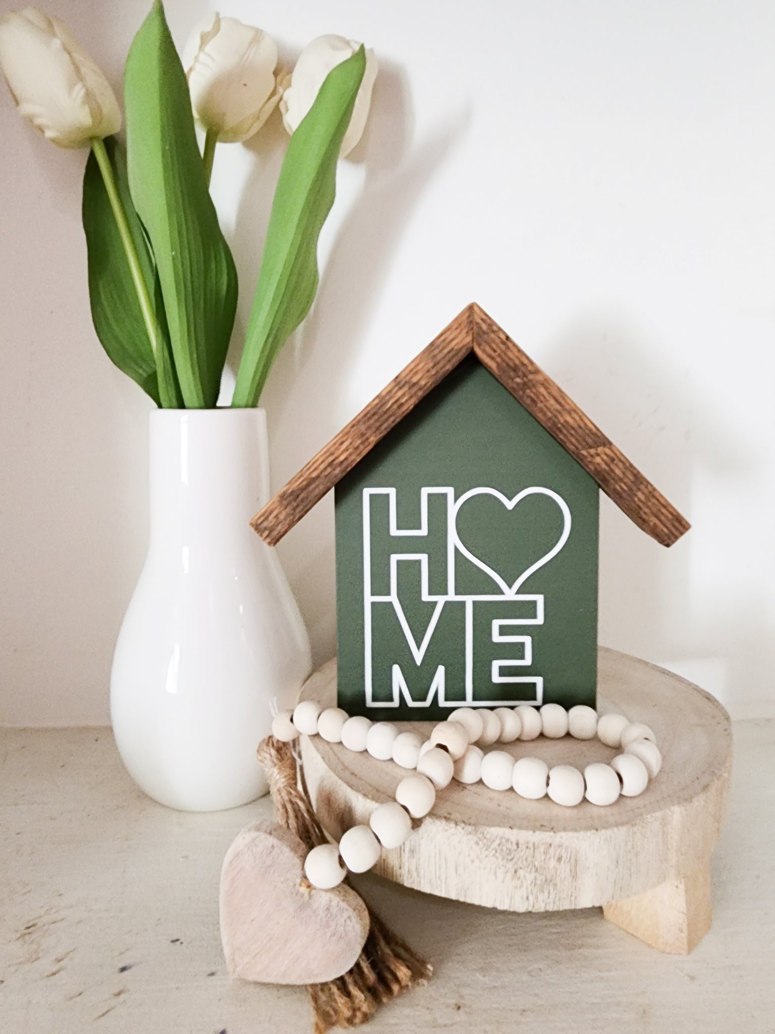 Small rustic house "Heart Home " sign. Dark green