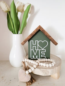 Small rustic house "Heart Home " sign. Dark green