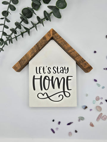 Small rustic house "let's stay home" sign-